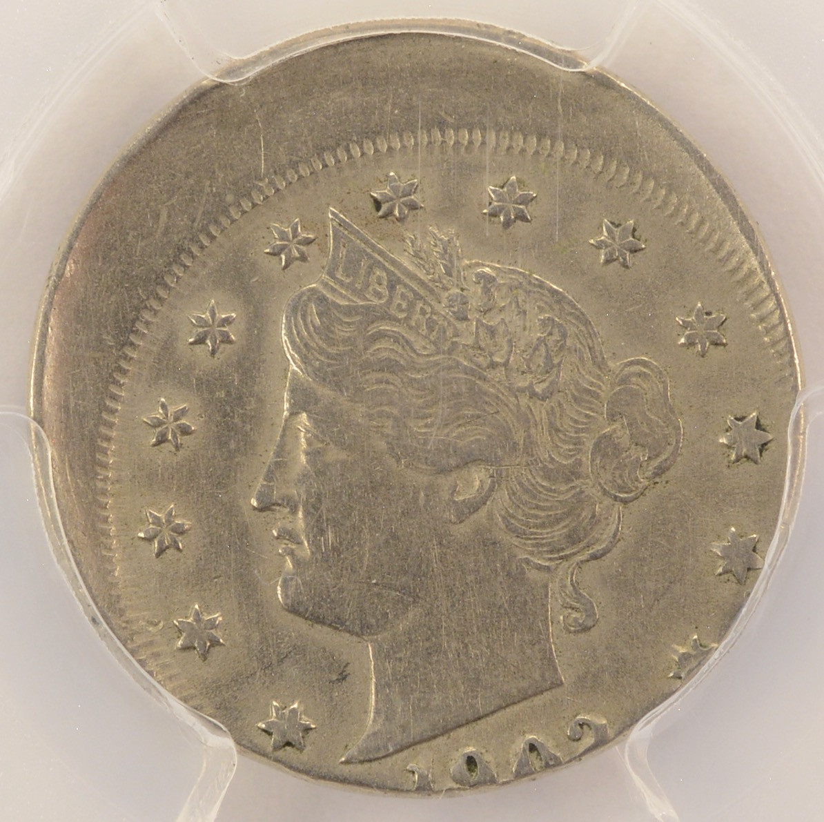1902 Liberty nickel off-center strike showing blank planchet area and partial design elements